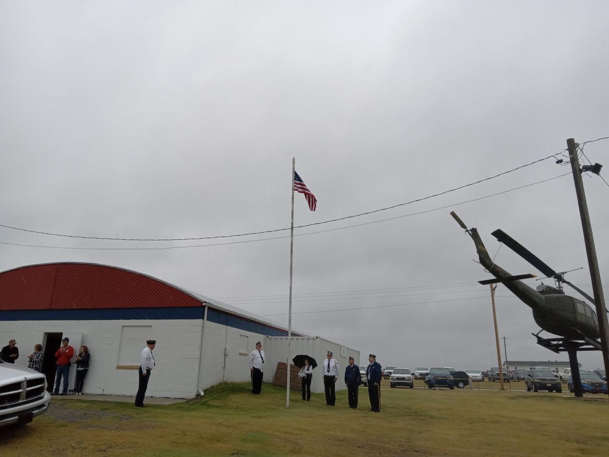 Legion members raising and saluting flag