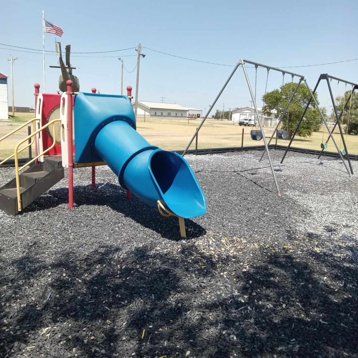 Blue tube slide and children's swings